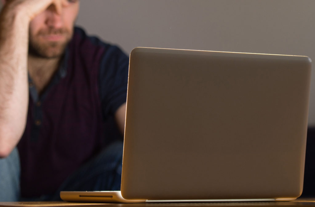 Online sexual grooming stock. PICTURE POSED BY MODEL A man using a laptop. Picture date: Monday March 9, 2015. Photo credit should read: Dominic Lipinski/PA Wire URN:22516543